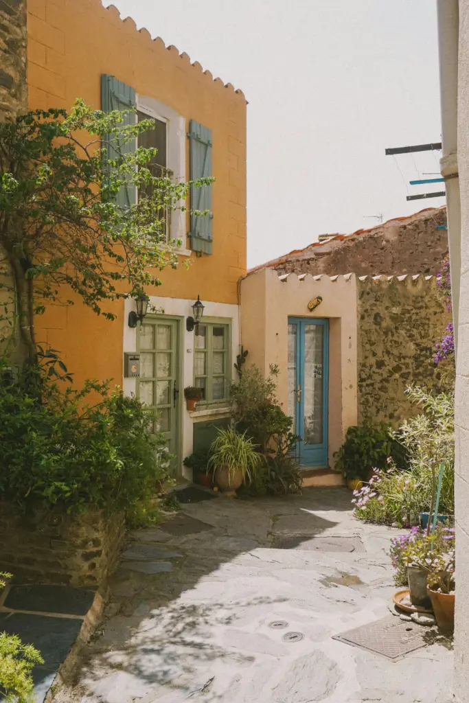 Ruelle colorée du vieux Collioure avec façades ocre et volets bleus, à 5 minutes de la maison de location à Port-Vendres